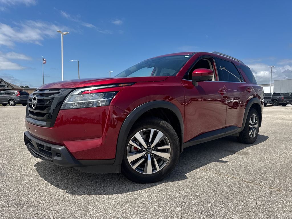 2024 Nissan Pathfinder SL in Scarlet — front three-quarter view